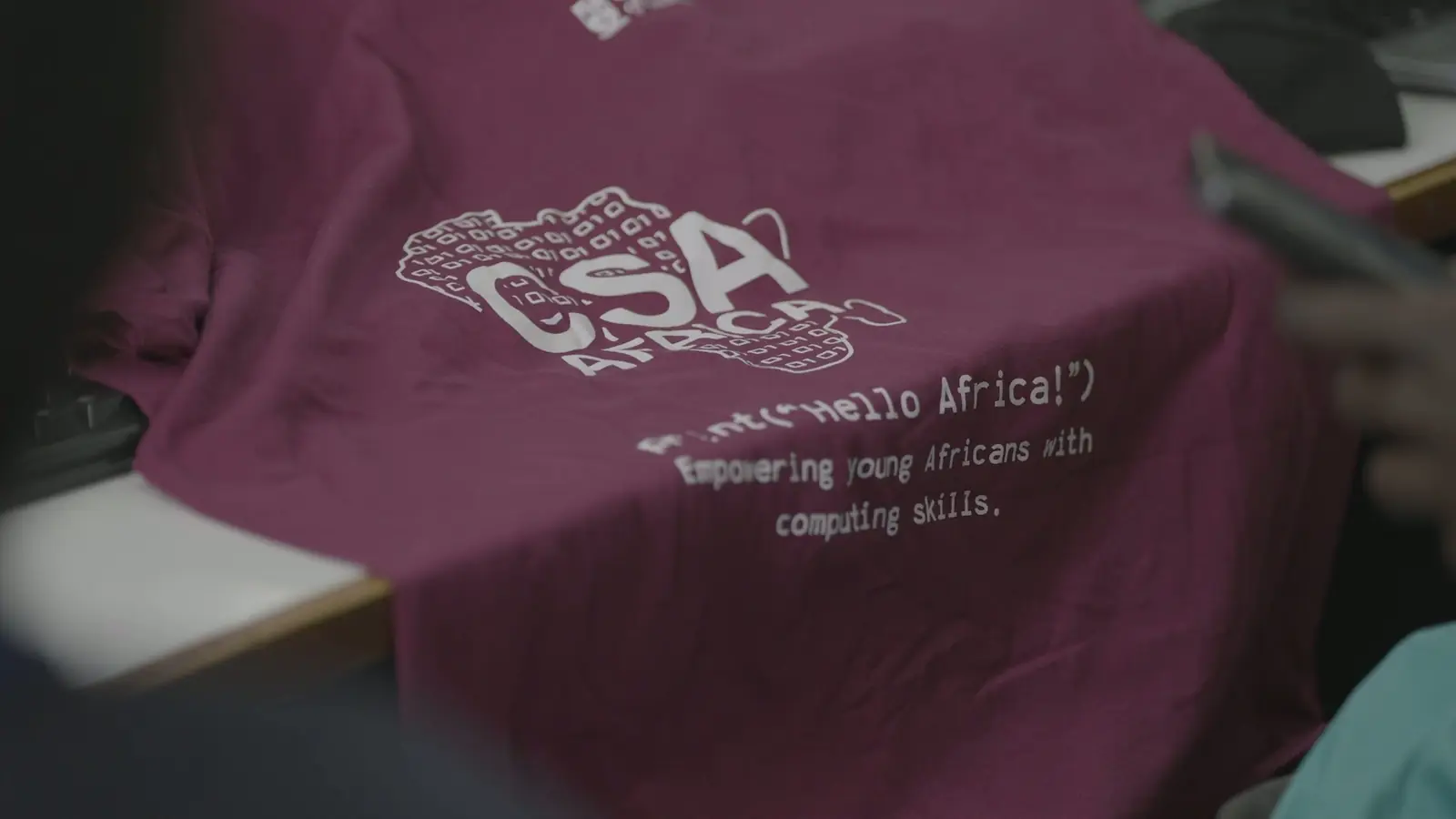 A CSA Africa t-shirt printed with the words: Empowering young Africans with computing skills