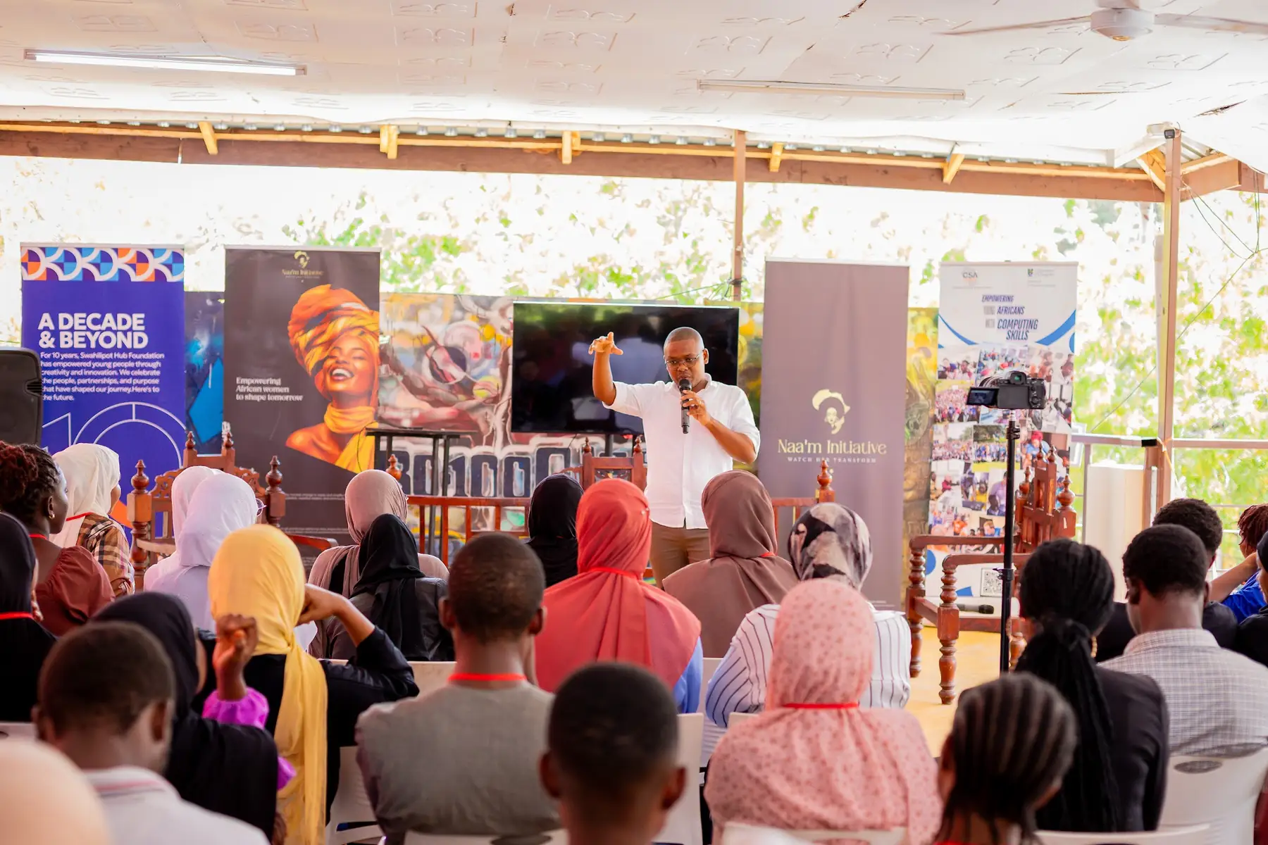 A panel seated at the front while participants watch