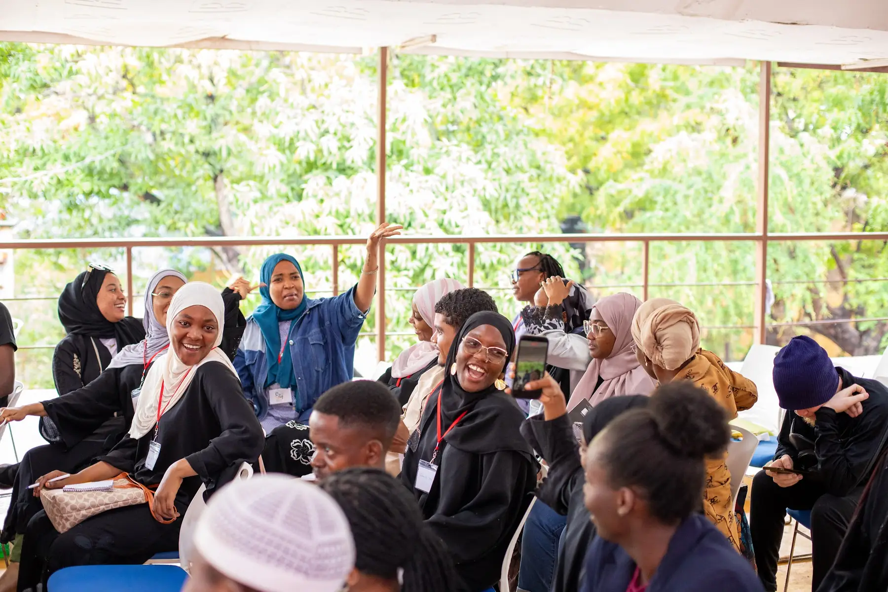 Participants with hands raised during a session