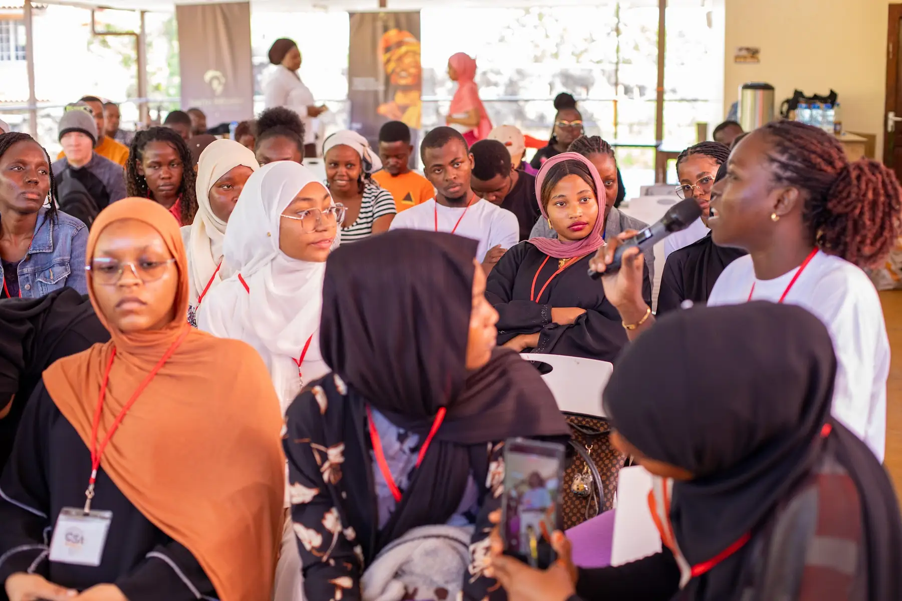 Participants listening closely in a crowded room